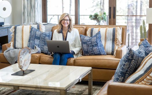 Durango realtor Kelly Kniffin working on computer on leather couch